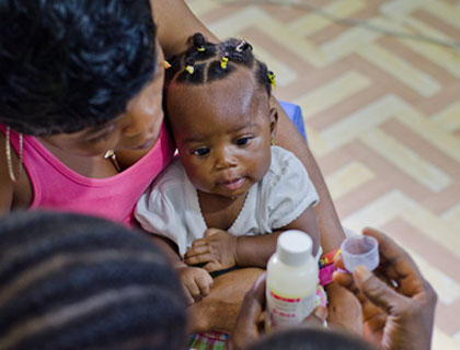 Toddler looking at medicine