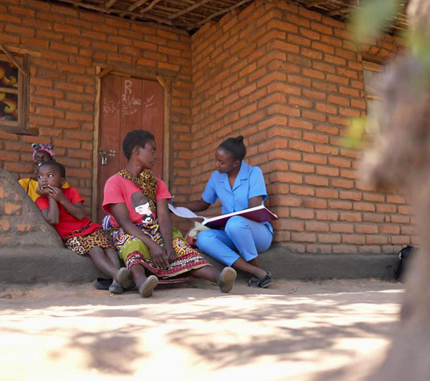 community health worker doing routine checks with a mother