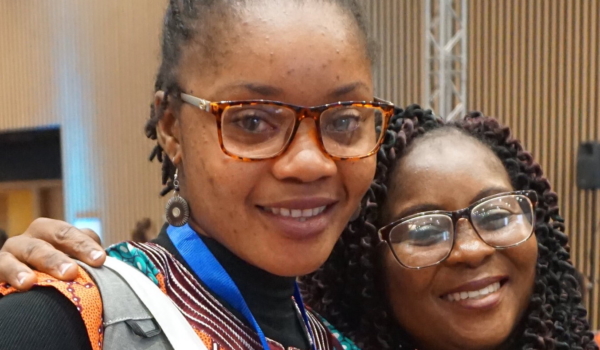 Estherlyn Peters and Featha Kolubah attend the Women Leaders in Global Health conference.
