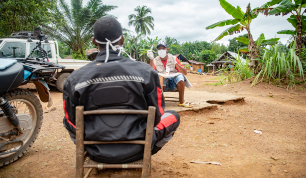 Community Health Worker Jerome Gardiner has a socially-distanced supervision visit in Liberia.